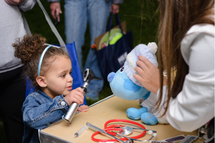 A child learning about the College of Human Medicine at the Teddy Bear Health Fair.